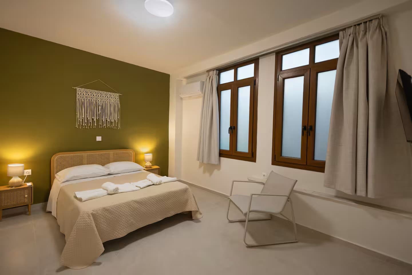 The bedroom, made up with white linen