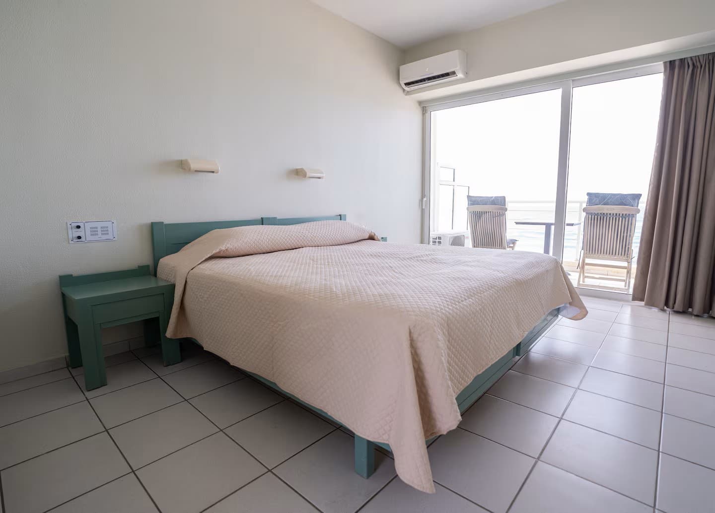 The bedroom, made up with white linen